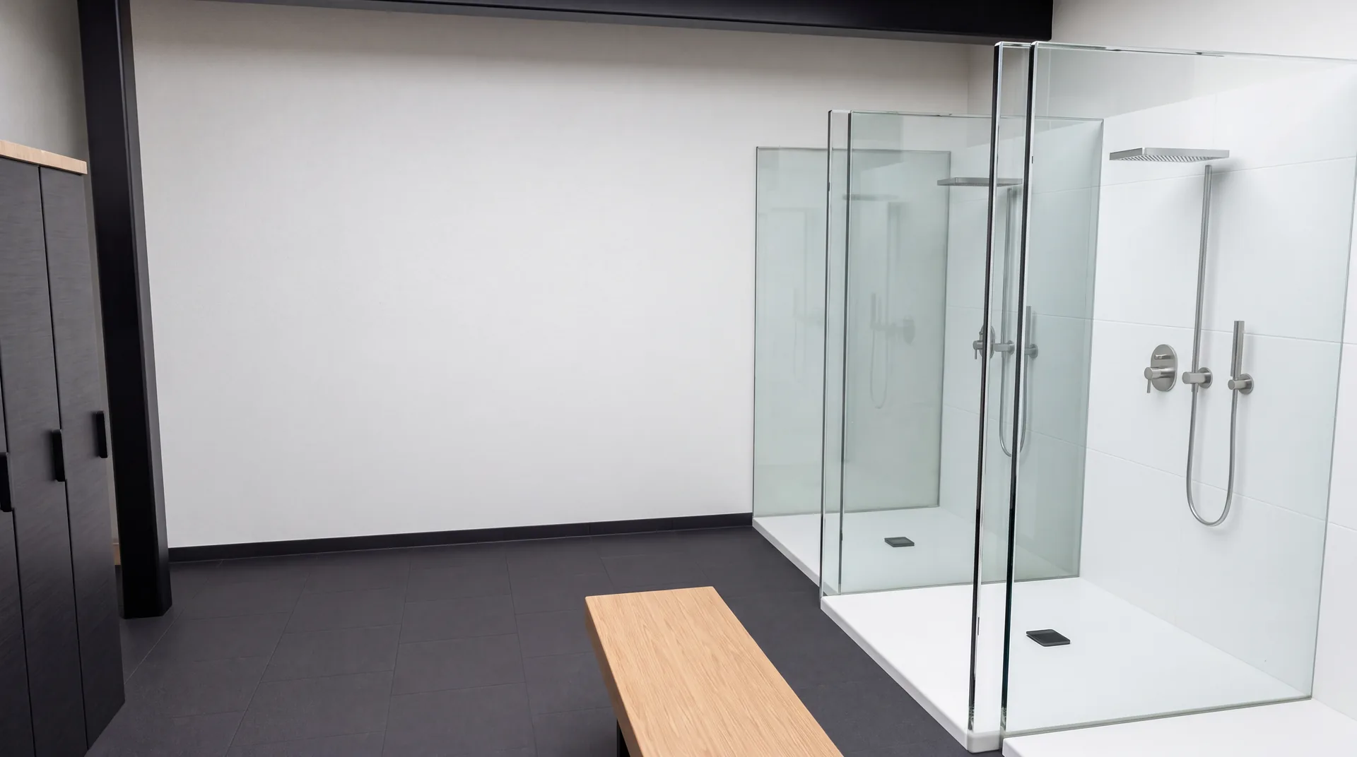 Concept rendering of the academy’s locker and shower area with black lockers and glass shower doors